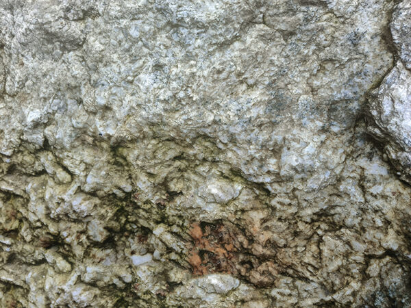 a large rock with a brown spot on it