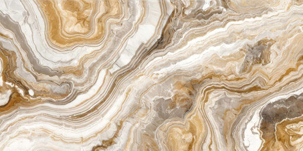 The image is a close-up of a marble surface. The marble has a unique pattern of swirls and curves, with different shades of beige, brown, and white. The colors blend together to create a beautiful and intricate design. The surface appears to be smooth and polished, with visible veins and grooves running through it. The overall effect is one of luxury and sophistication.